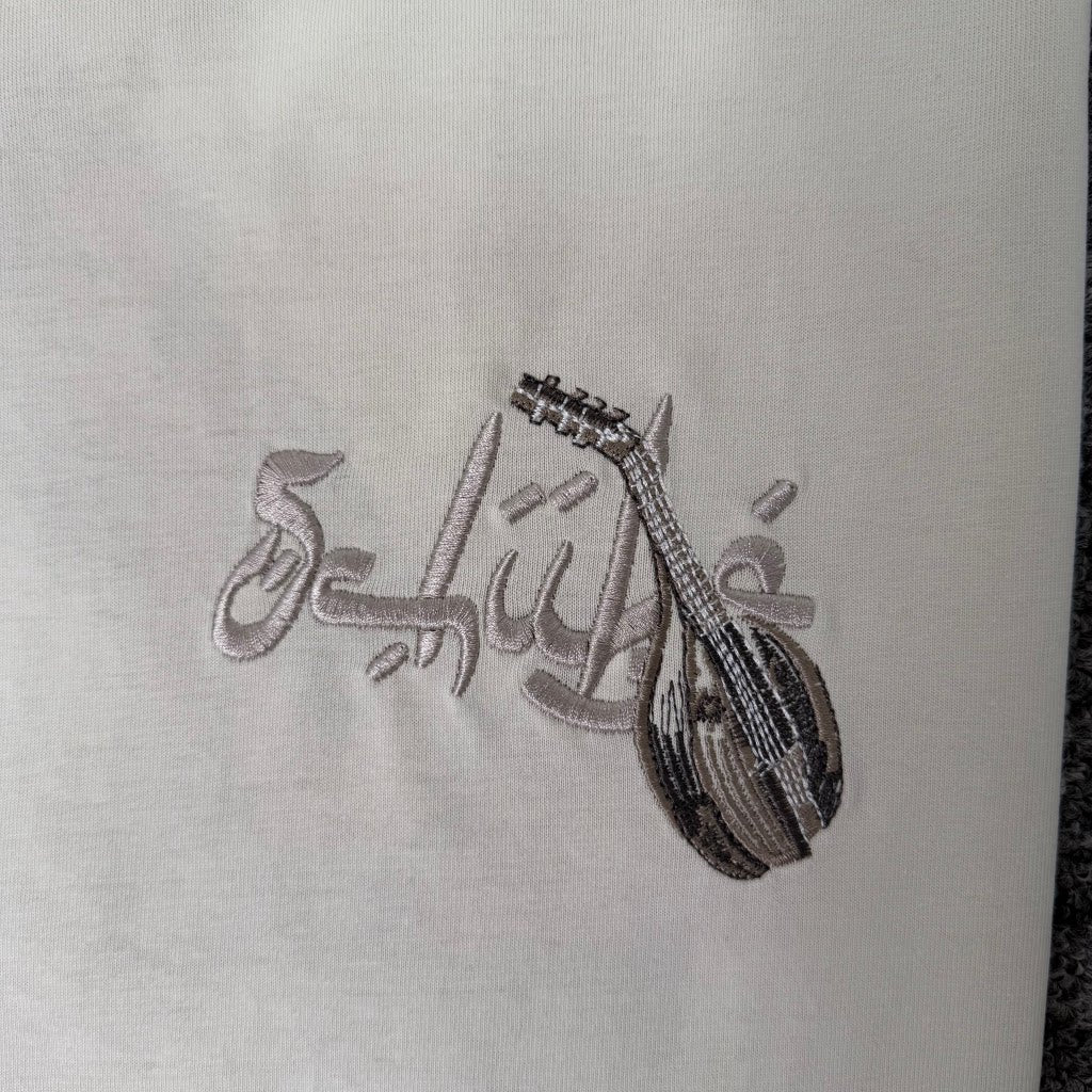 Derschutze Cream Middle Eastern Scholar Musician Back‑Print Graphic Tee