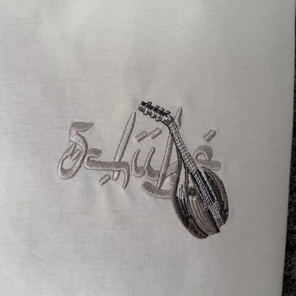 Derschutze Cream Middle Eastern Scholar Musician Back‑Print Graphic Tee